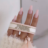 Bracelet « J’adore » blanc rose doré